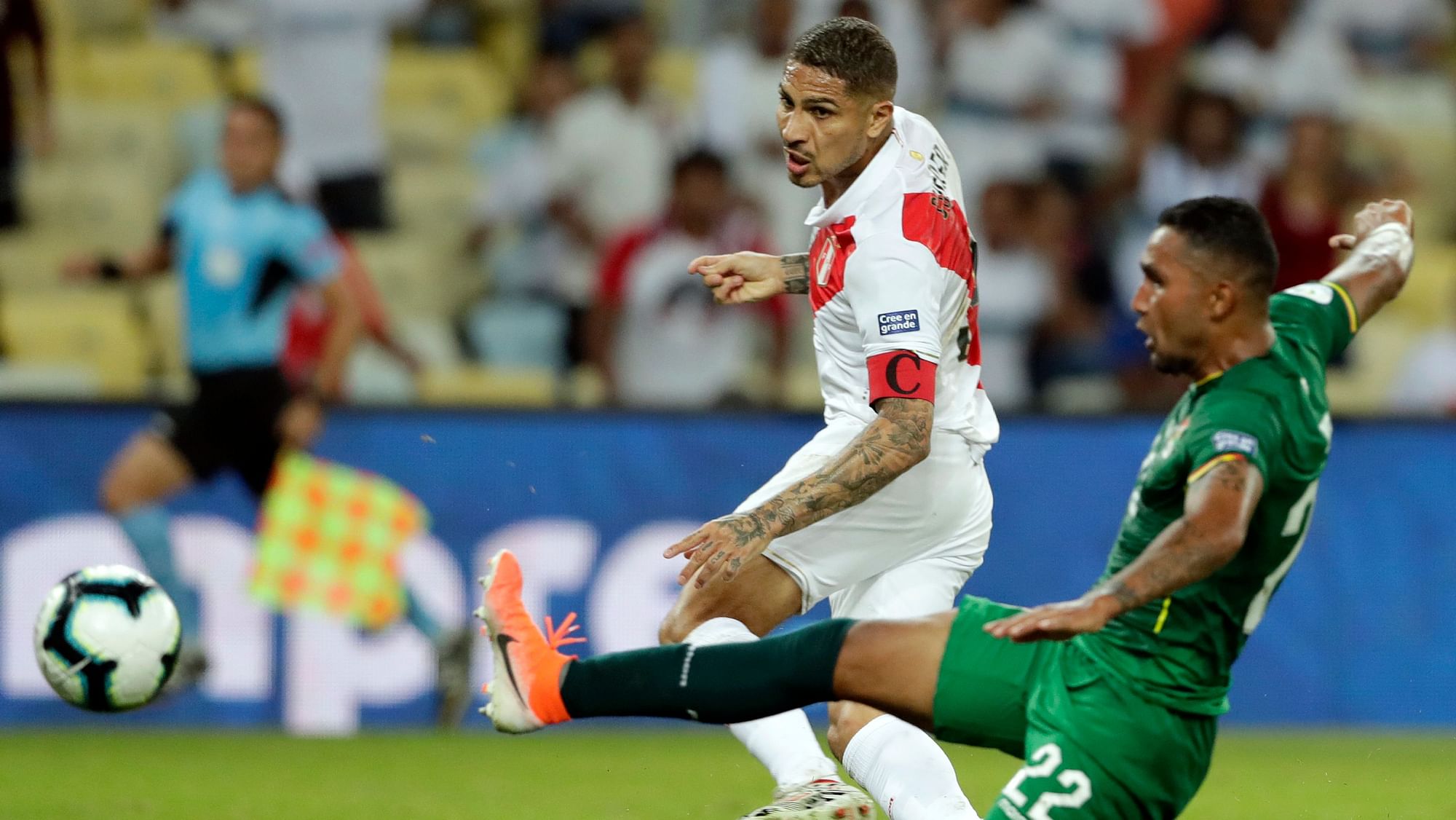 Guerrero strike the ball past Bolivia’s Adrian Jusino, to score his team’s equalizer during a Copa America.