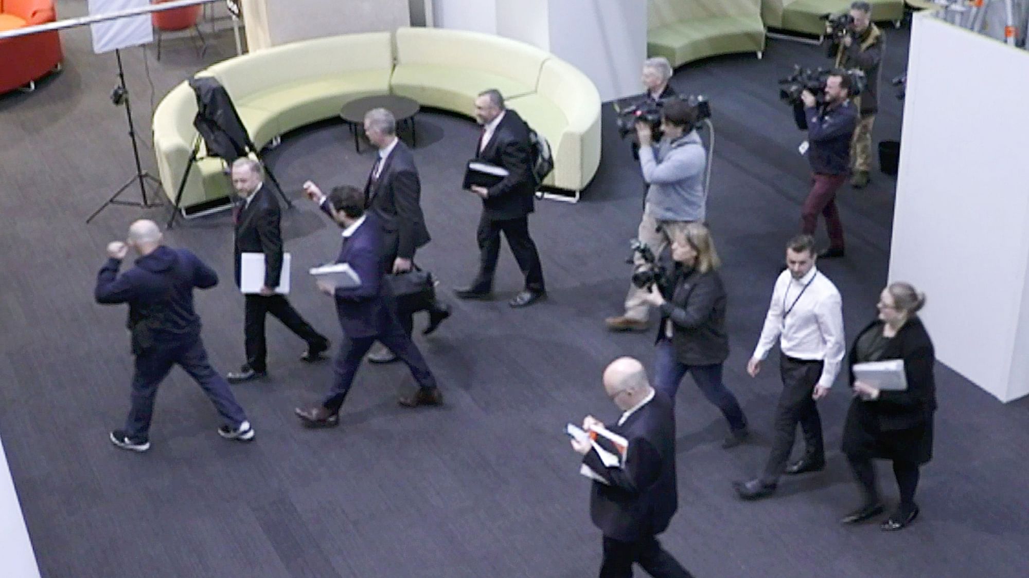 In this image made from video, Australia’s Federal Police, top, enter the Australian Broadcasting Corporation, the national public broadcaster, during a raid on their offices in Sydney, Australia.