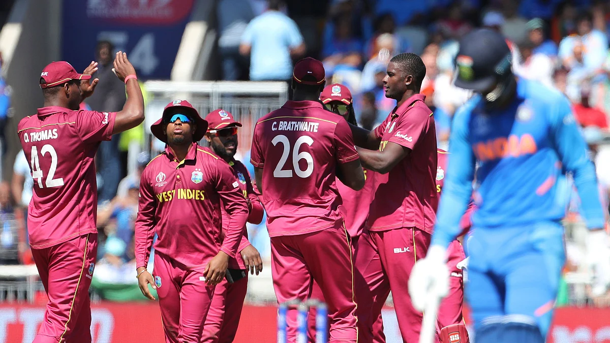 West Indies’ captain Jason Holder, second right, celebrates with teammates the dismissal of India’s K.L. Rahul.