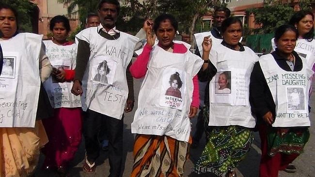 Nagarani (centre) protests along with other families who were affected by MSS in Delhi in 2013.
