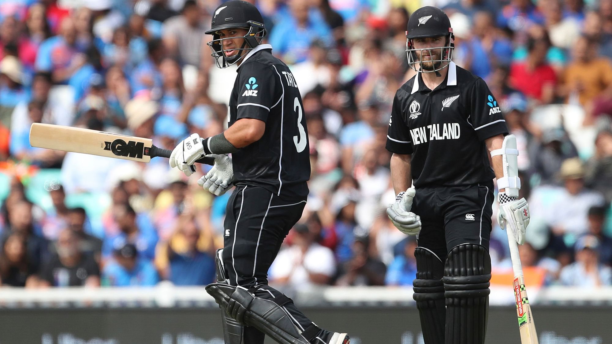 New Zealand captain Kane Williamson, right, watches as teammate Ross Taylor celebrates scoring fifty runs during the Cricket World Cup