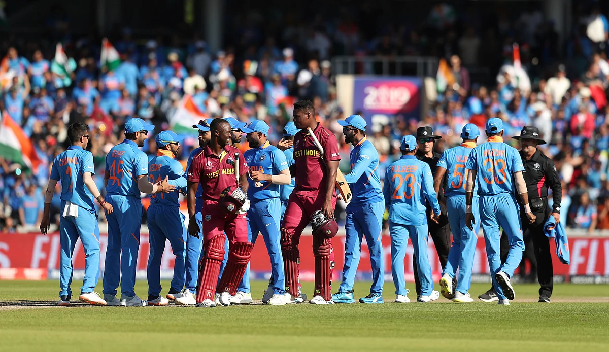Cricketers converge in the field at the end of the Cricket World Cup match between India and West Indies at Old Trafford.