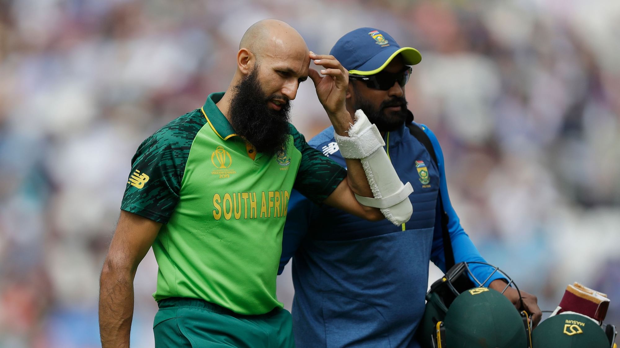 Hashmim Amla being escorted off the ground after he got injured against England.