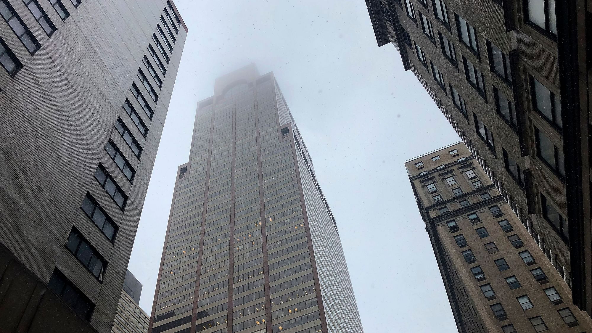 Mist and smoke cover the top of a building near 51st Street and 7th Avenue Monday, June 10, 2019, in New York, where a helicopter was reported to have crash landed on top of the roof of a building in midtown Manhattan.&nbsp;