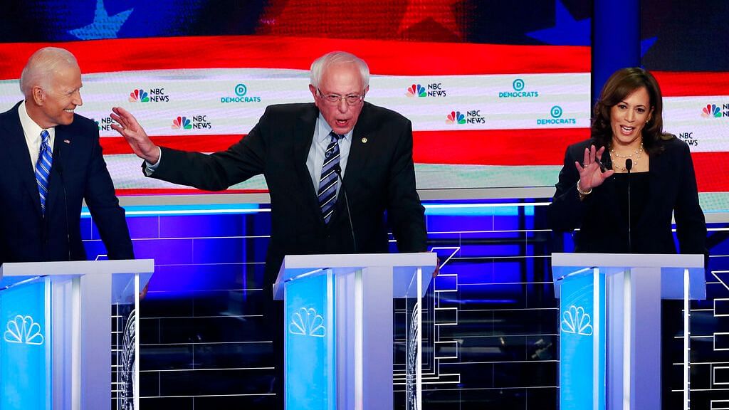Democratic presidential candidate Sen. Bernie Sanders gestures towards former vice president Joe Biden, as Sen. Kamala Harris talks during the Democratic primary debate hosted by NBC News.&nbsp;