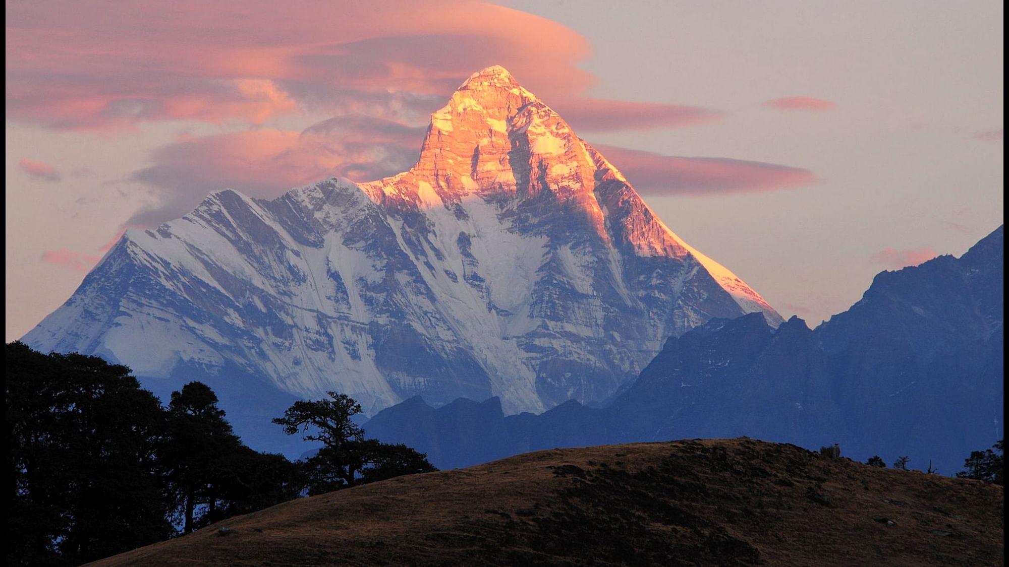 Indian air force pilots are scouring the Himalayan peak to search for the remaining three missing climbers.