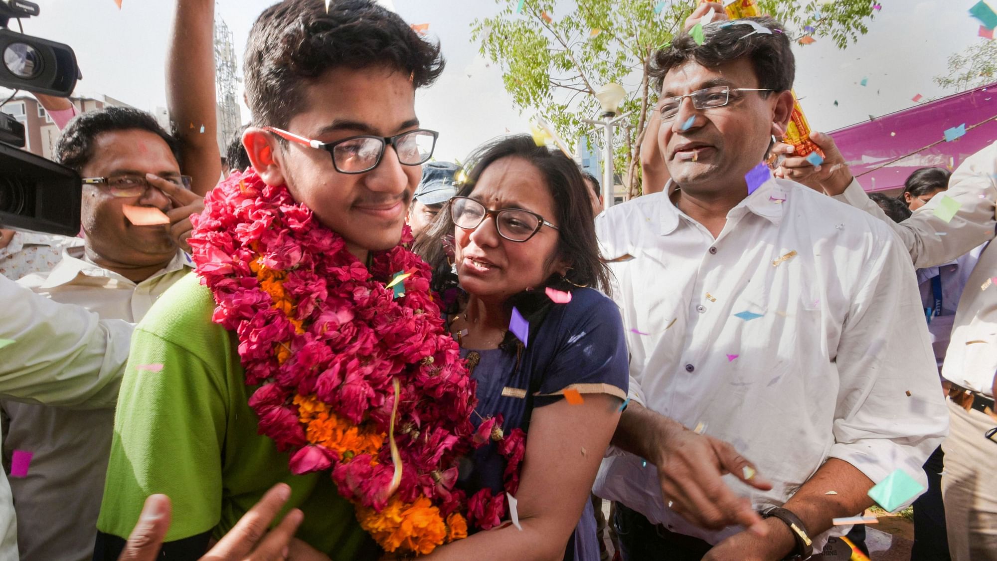 All India National Eligibility cum Entrance Test (NEET) topper Nalin Khandelwal celebrates with his parents after the declaration of results in Jaipur.