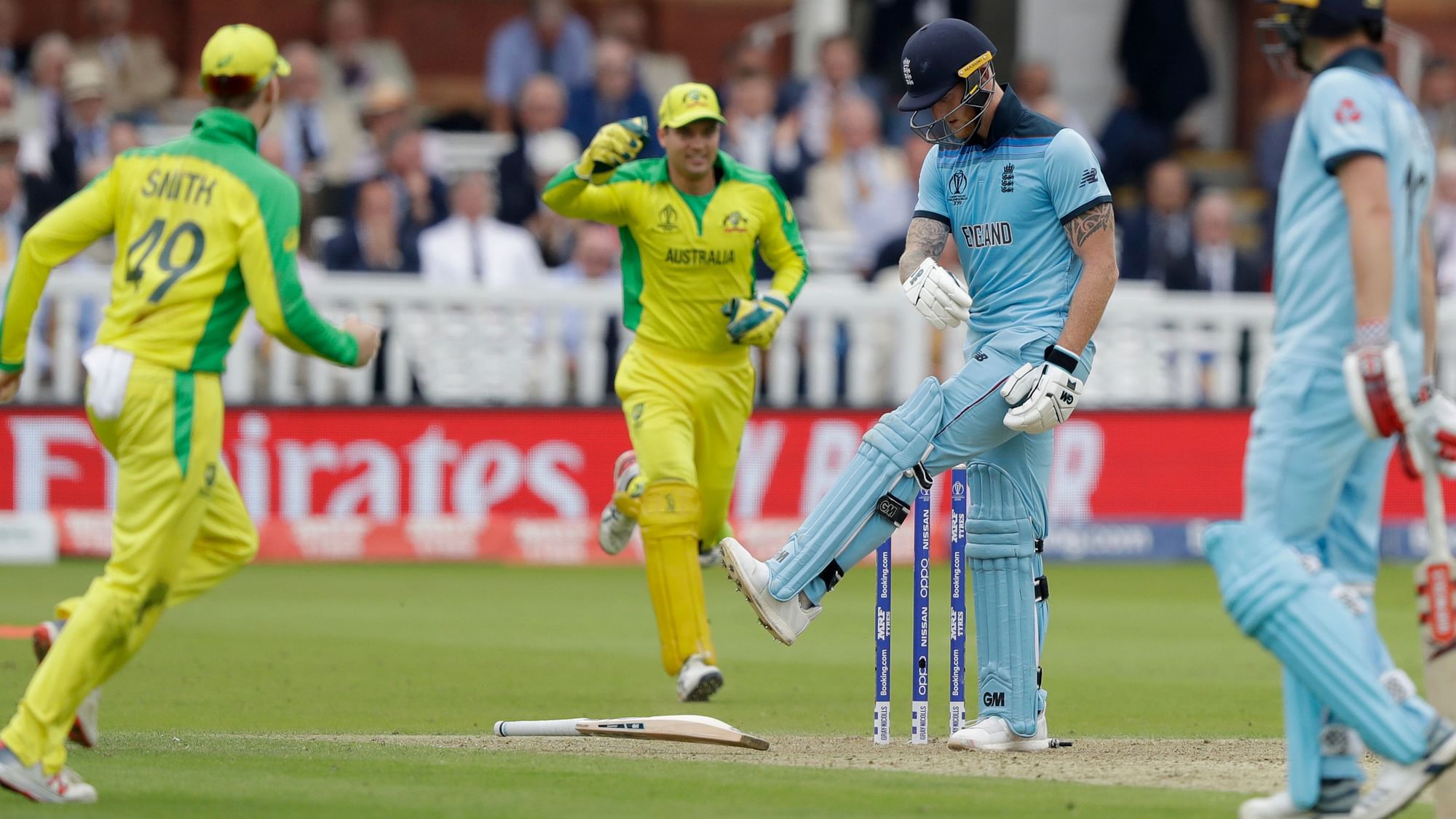England’s Ben Stokes kicks his bat after being clean bowled by Australia’s Mitchell Starc, as Australia’s Steve Smith looks on during the Cricket World Cup match between England and Australia at Lord’s.&nbsp;