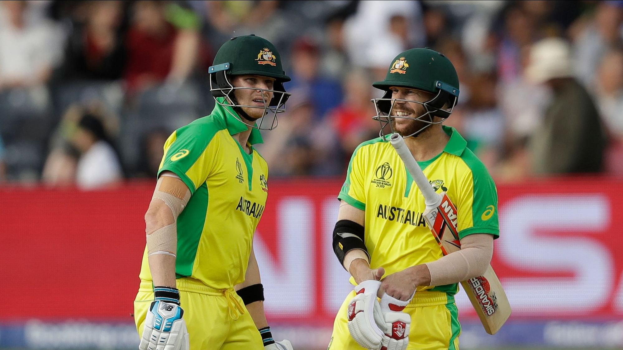 Australia’s Steve Smith, left, and Australia’s David Warner chat after their first batting over together during the Cricket World Cup match between Afghanistan and Australia at Bristol County Ground in Bristol, England, Saturday, June 1, 2019.&nbsp;