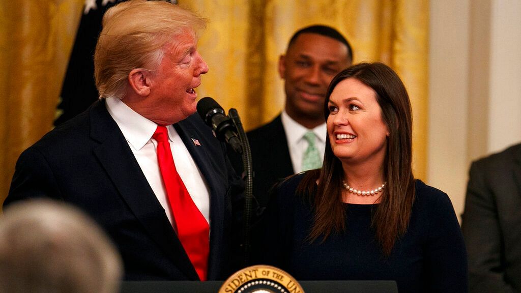 President Donald Trump welcomes White House press secretary Sarah Sanders to the stage as he pauses from speaking about second chance hiring to publicly thank the outgoing press secretary in the East Room of the White House on Thursday 13 June, 2019, in Washington.