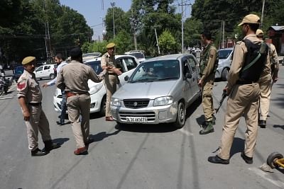 Srinagar: Police personnel frisking vehicles amid high security arrangements that have been made ahead of Union Home Minister Amit Shah
