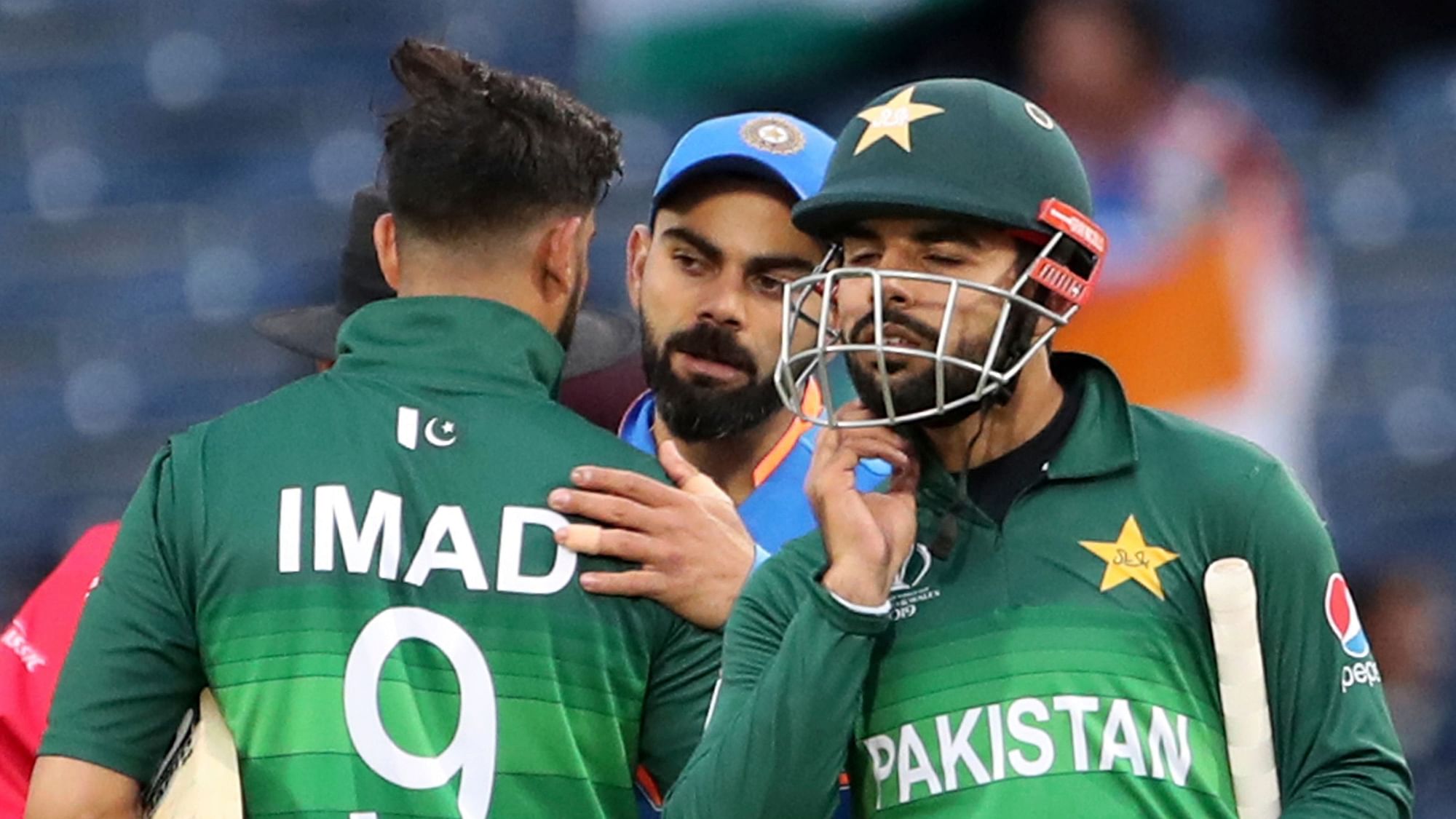 India’s captain Virat Kohli, center, greets Pakistan players at the end of the Cricket World Cup match between India and Pakistan.
