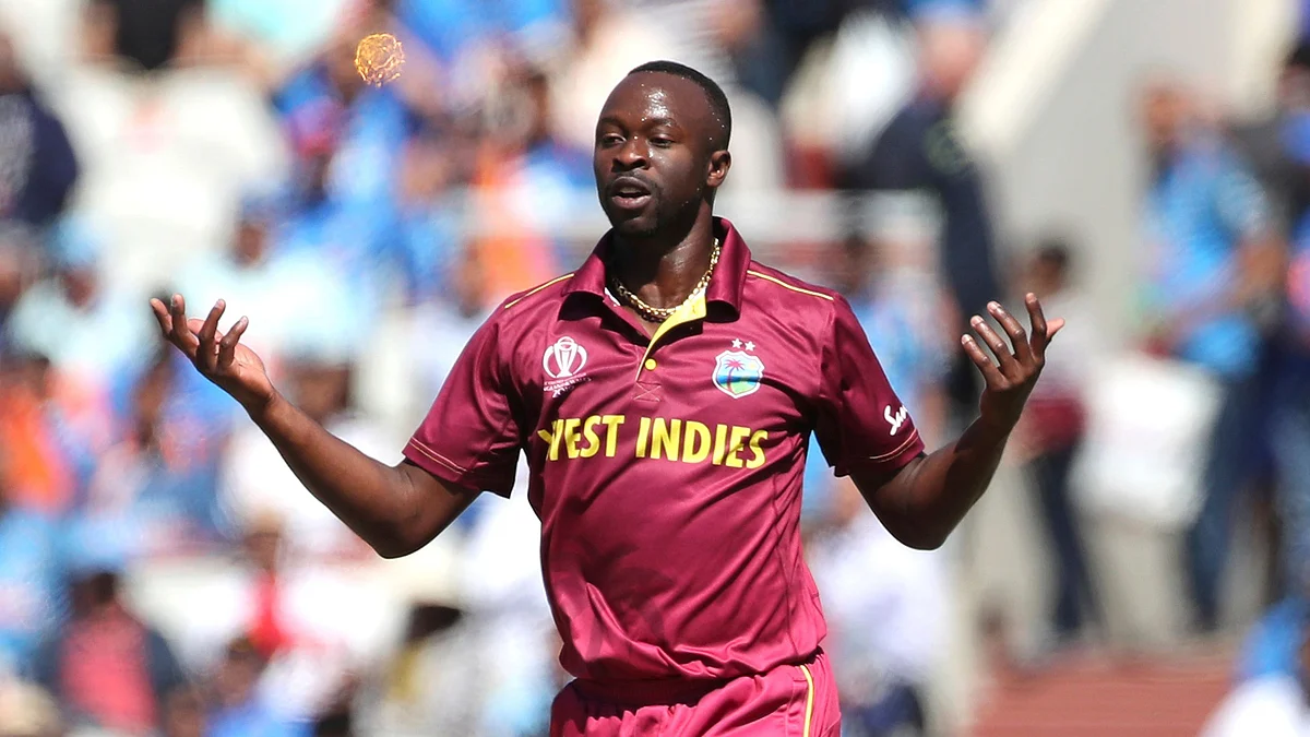 West Indies’ Kemar Roach celebrates the dismissal of India’s Rohit Sharma.