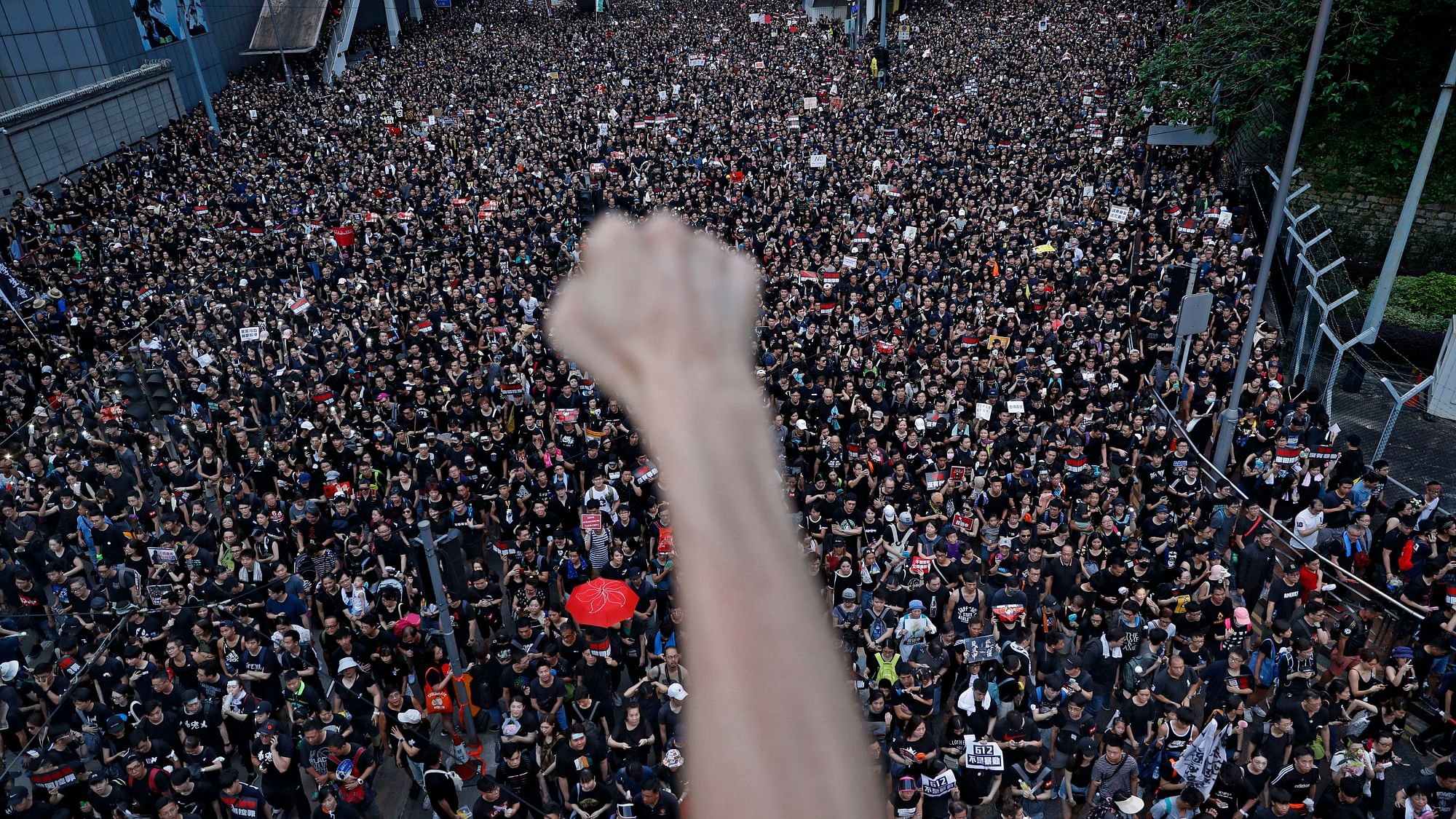 Protesters march on the streets against an extradition bill in Hong Kong on Sunday, 16 June 2019. Hong Kong residents were gathering Sunday for another massive protest over an unpopular extradition bill