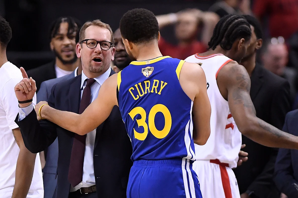 Toronto Raptors head coach Nick Nurse and Golden State Warriors guard Stephen Curry (30) exchange words.