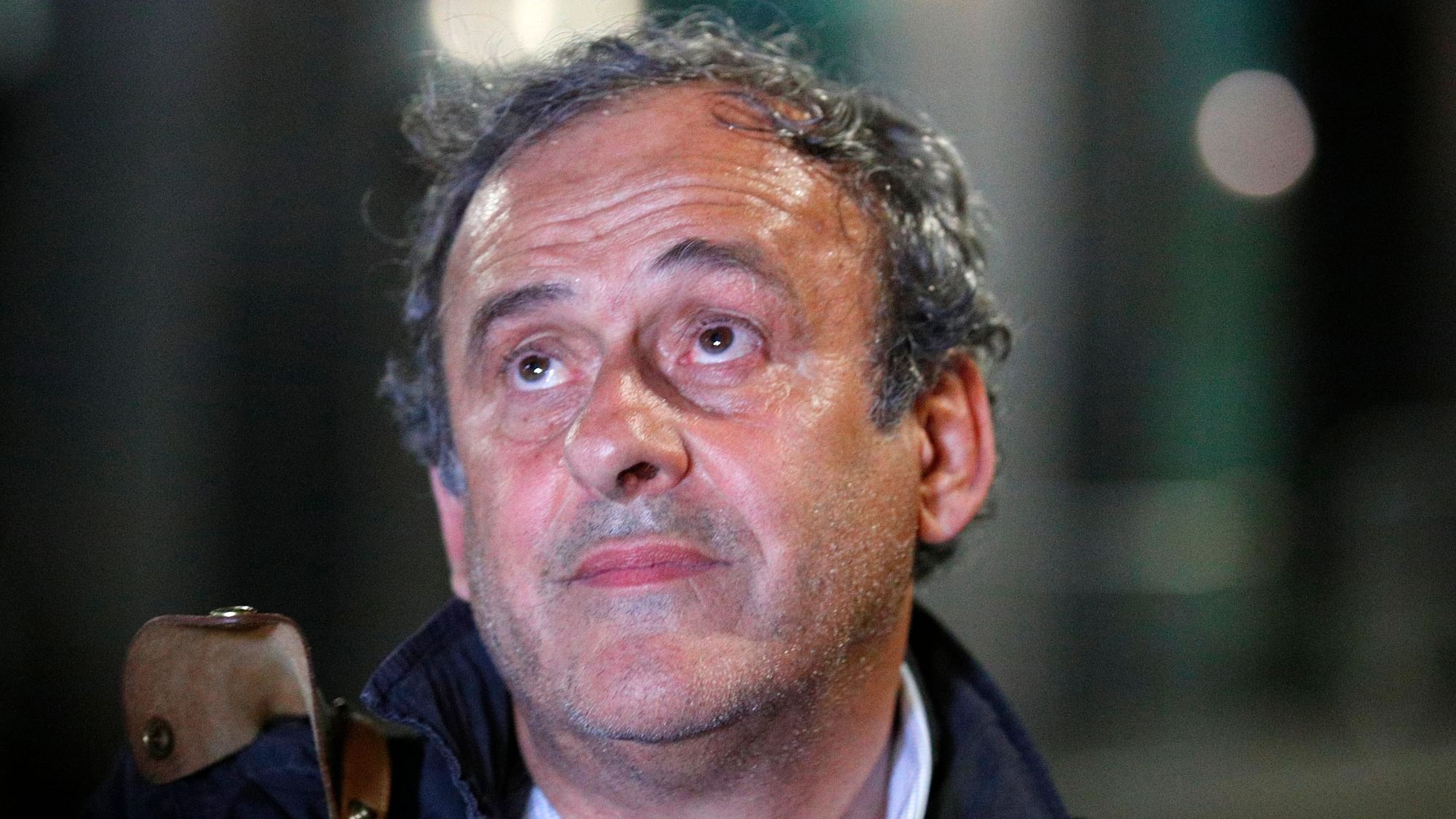 Michel Platini looks up after being freed, outside the French police anti-corruption and financial crimes office in Nanterre.