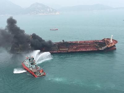HONG KONG, Jan. 8, 2019 (Xinhua) -- A rescue boat puts out fire that occurred on an oil tanker off Hong Kong
