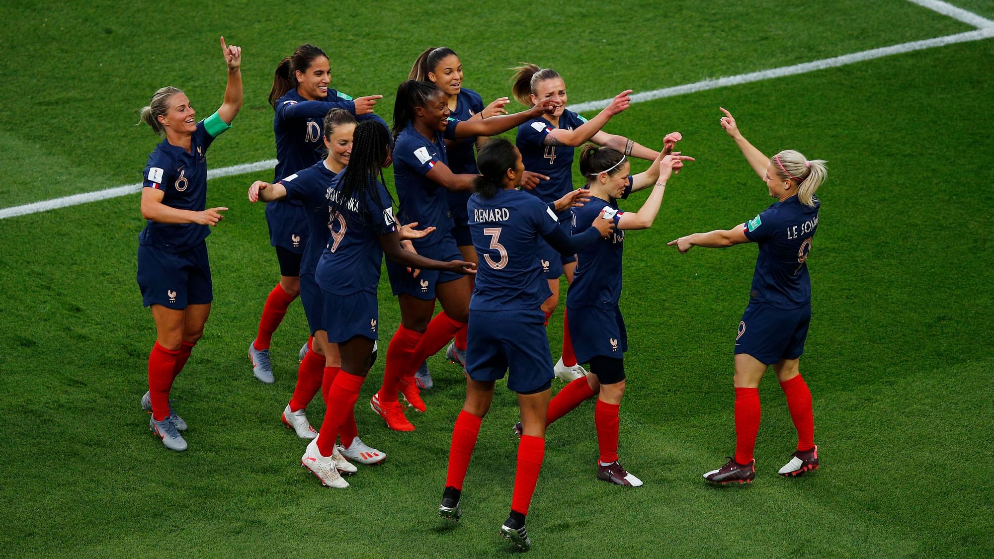France’s Eugenie Le Sommer (R) celebrates with her teammates after scoring her side’s opening goal.