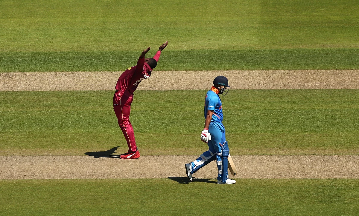 West Indies’ Sheldon Cottrell celebrates after taking the wicket of India’s Mohammed Shami.