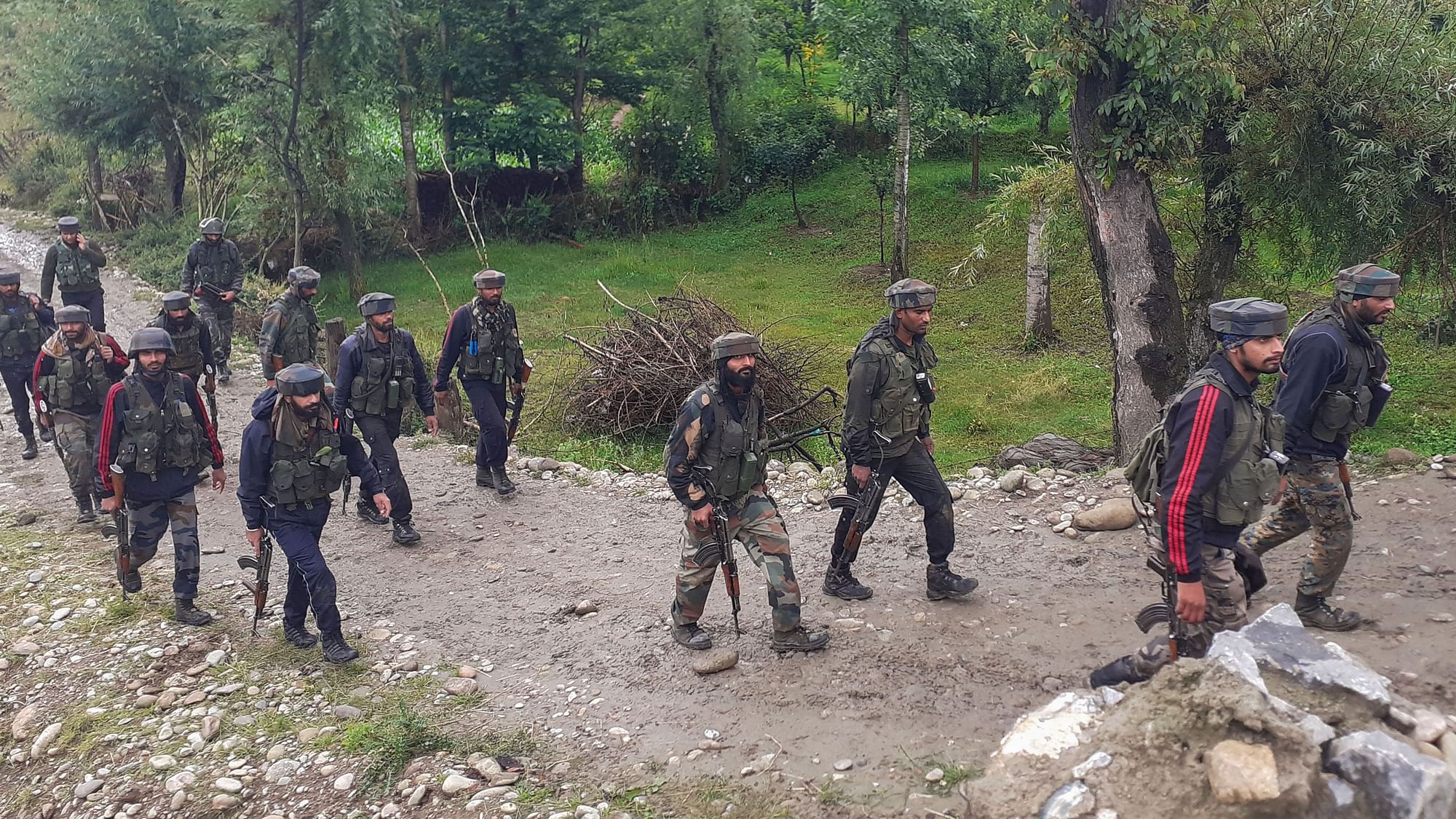 Soldiers move towards the site of an encounter in which four Ansar-Ul-Gazwatul-Hind militants were killed, in Shopian