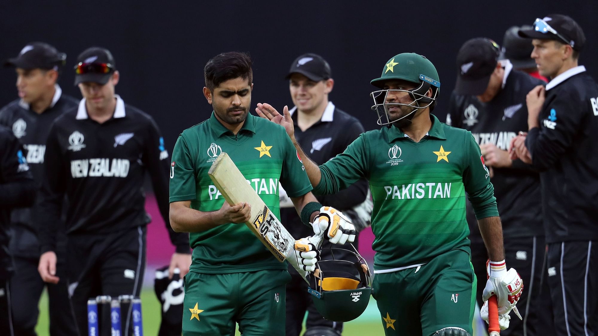 Pakistan’s captain Sarfaraz Ahmed, right, pats on the shoulder teammate Babar Azam for scoring a century at the end of the Cricket World Cup match between New Zealand and Pakistan.