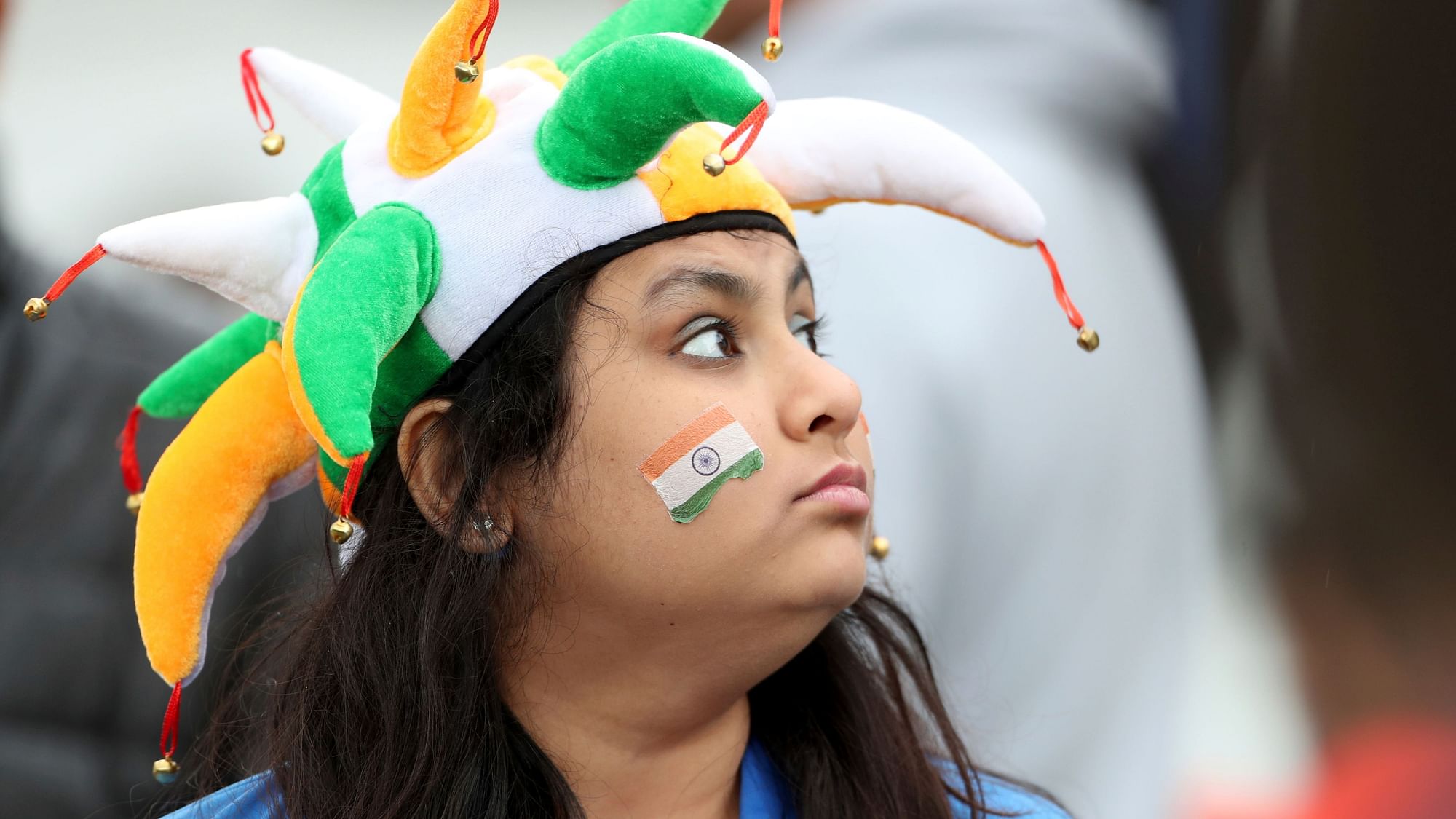 A fan looks skywards after rain delayed start of the Cricket World Cup match between India and New Zealand at Trent Bridge in Nottingham.