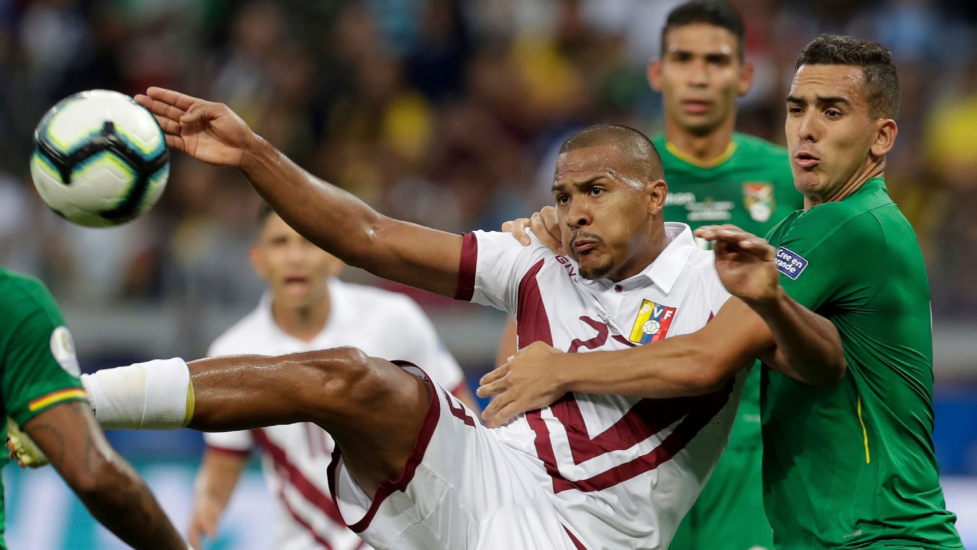 Venezuela’s Salomon Rondon, left, fights for the ball with Bolivia’s Marvin Bejarano during a Copa America Group A soccer match at Mineirao stadium in Belo Horizonte, Brazil.