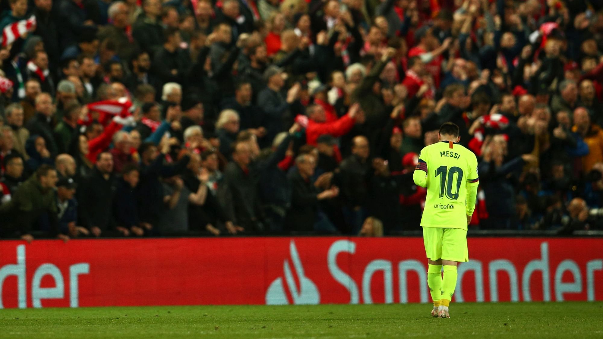 Barcelona’s Lionel Messi walks as Liverpool’s Divock Origi celebrates scoring his side’s 4th goal during the Champions League semifinal.