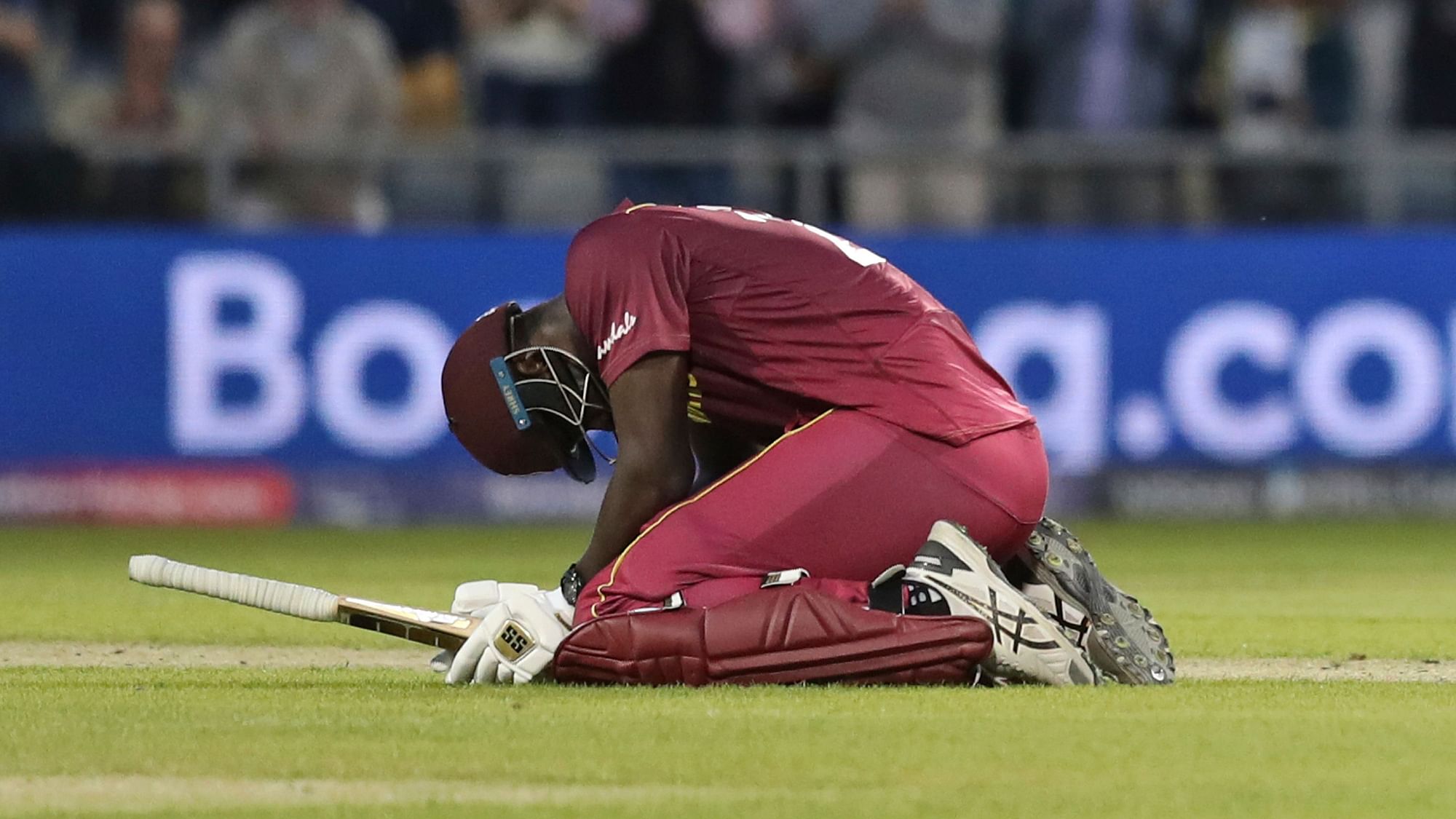 West Indies’ Carlos Brathwaite reacts after losing the Cricket World Cup match against New Zealand at Old Trafford in Manchester, England.