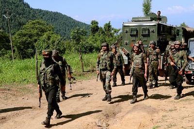 Pulwama: Security forces during a cordon and search operation after a militant was killed in a gunfight in Branpathri forest area of Tral in Jammu and Kashmir