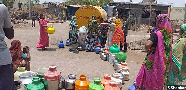 Government water tankers are supposed to provide 40 litres of water per person every day, but the villagers complain that they get only 15-20 litres (two to three pots). A queue at a water tanker in Mole village of Athani taluka in northern Karnataka. 