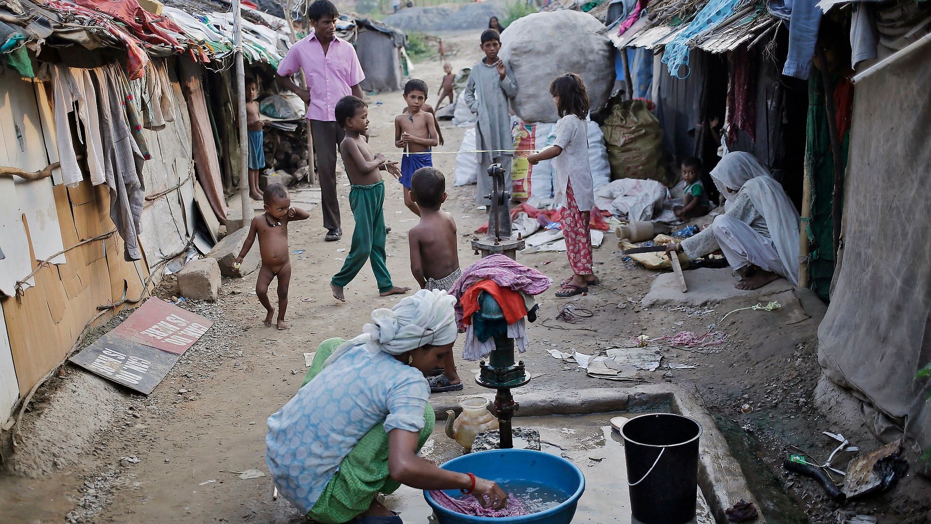  A woman washes clothes inside a Rohingya camp in India.