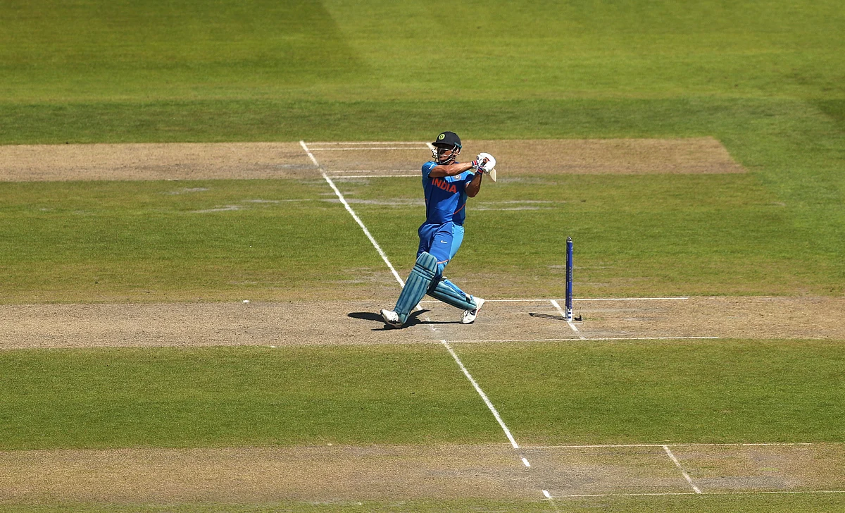 India’s Mahendra Singh Dhoni scores a four as he bats during the last over of the Cricket World Cup match between India and West Indies.