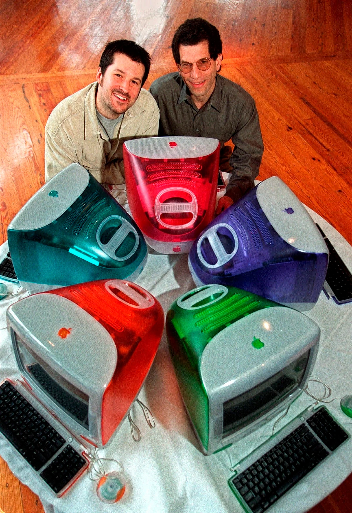 This March 19, 1999 file photo shows Jonathan Ive (left) and Apple Computer’s vice president of design, and Jon Rubinstein, Apple’s senior vice president of engineering, posing behind five iMac personal computers at Apple headquarters in Cupertino, California. 