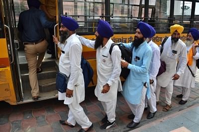 Amritsar: Sikh devotees board a bus as they leave for Pakistan to participate in 550th birth anniversary celebrations of Guru Nanak Dev, from Amritsar on July 30, 2019. (Photo: IANS)