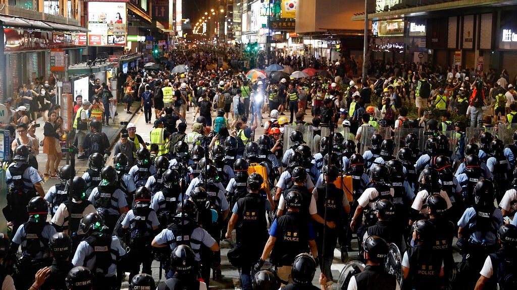 Layers of police officers face-off with protesters in Hong Kong on Sunday, 7 July.&nbsp;