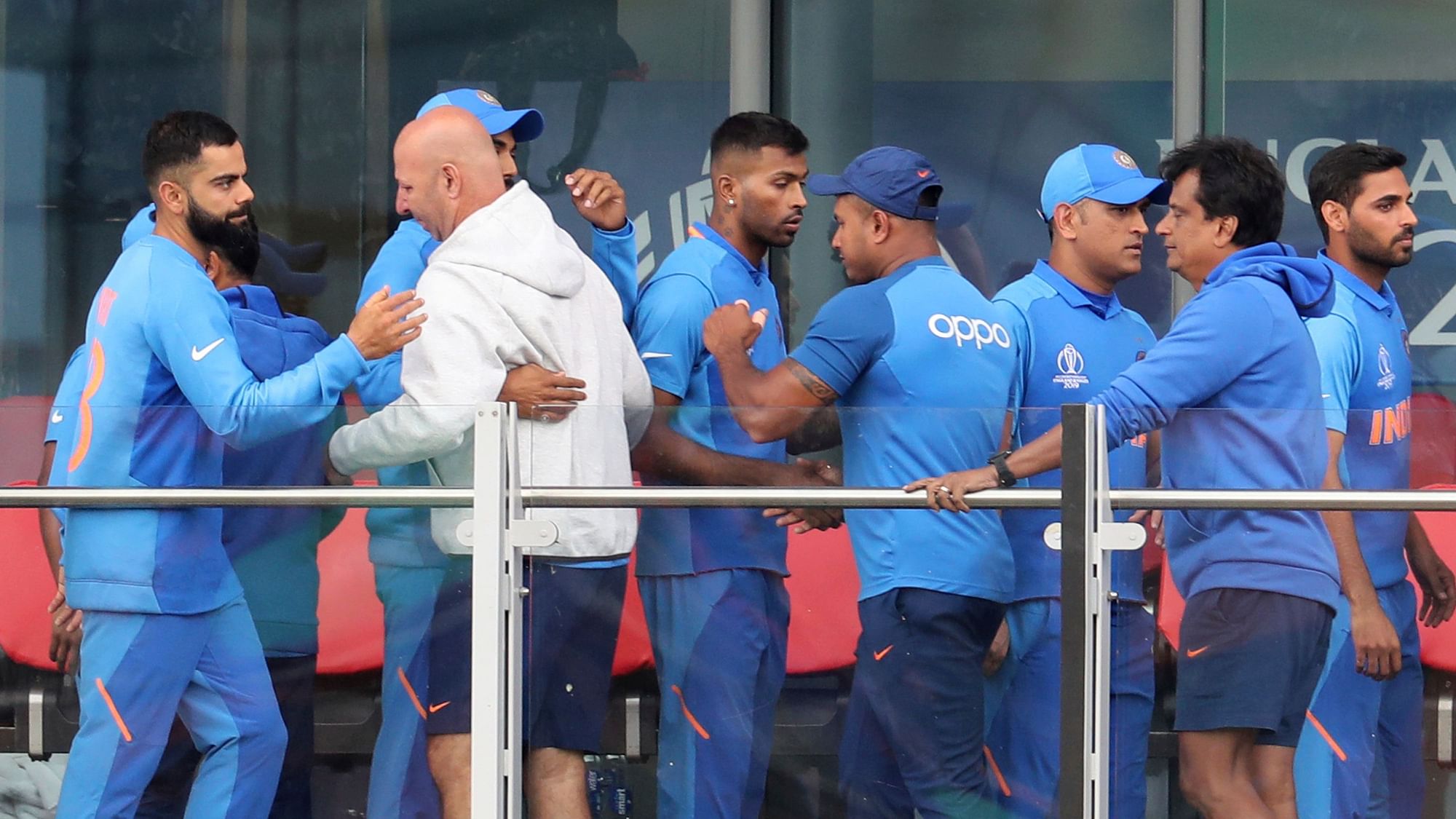 Indian cricketers greet each other after their team lost the Cricket World Cup semifinal match between India and New Zealand at Old Trafford in Manchester, Wednesday.