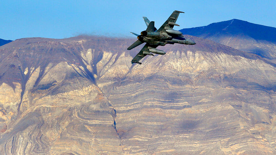 In this Feb 2017 photo, an F/A-18D Hornet from the VX-9 Vampire squadron at Naval Air Weapons Station China Lake, flies out of Star Wars Canyon toward the Panamint range in Death Valley National Park, California.