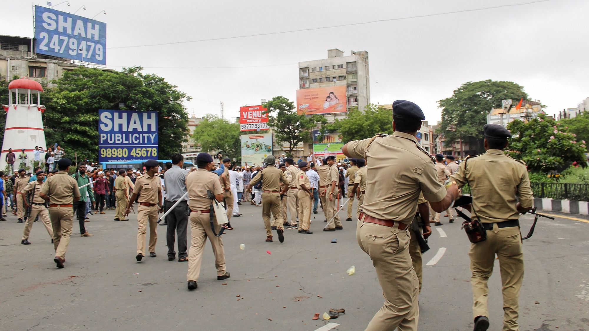 Policemen chase away protestors during a rally against incidents of mob lynching, in Surat on 5 July 2019.&nbsp;