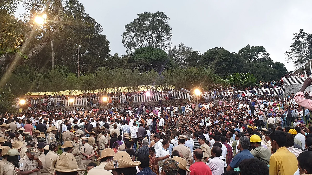 Villagers and estate workers gathered outside the house for the cremation.