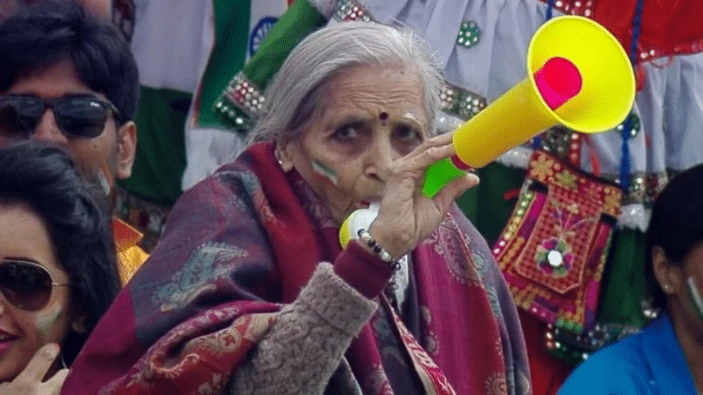 The passionate fan, identified as 87-year-old Charulata Patel, was seen cheering from the stand, blowing a trumpet with full zeal.