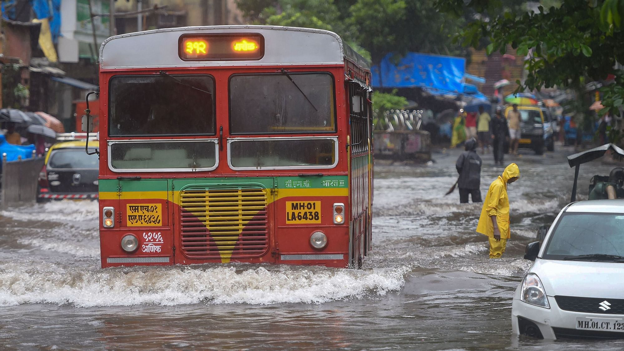 File image of vehicles moving slowly through a waterlogged street following heavy monsoon rain in Mumbai in July, 2019.