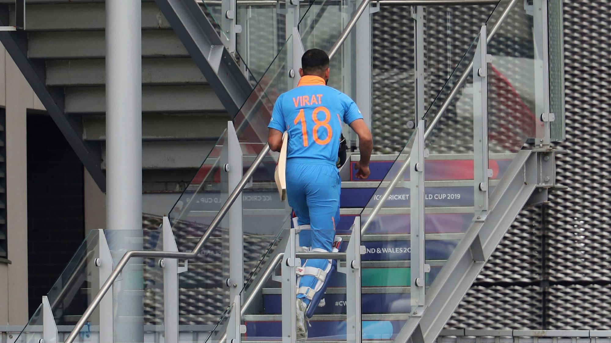 India’s captain Virat Kohli returns to the pavilion after being dismissed during the Cricket World Cup semifinal match between India and New Zealand at Old Trafford in Manchester.