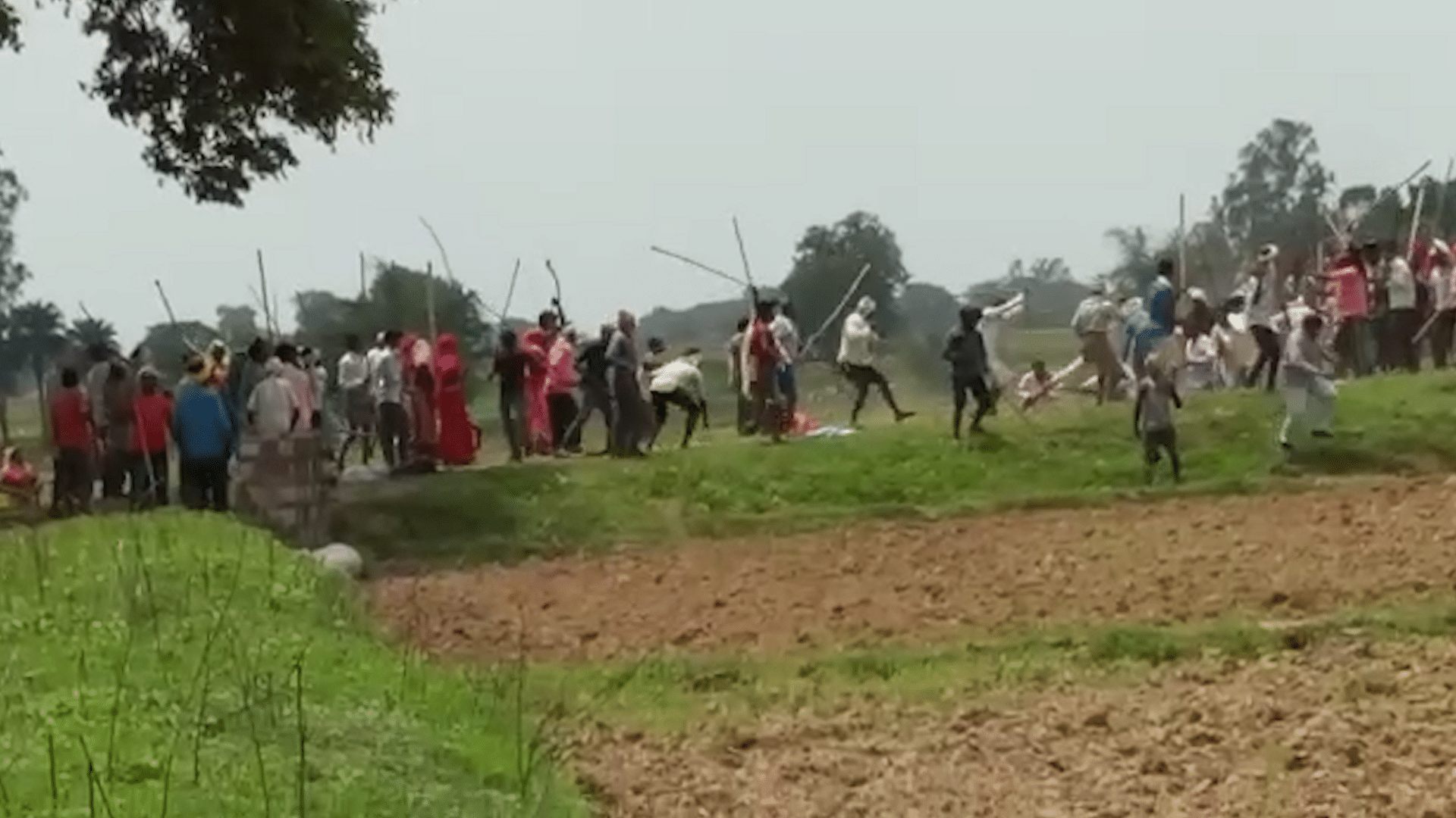 In one of the videos, a large number of people can be seen holding sticks and attacking another group of people.