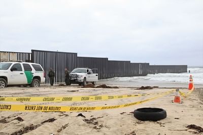 SAN DIEGO, May 1, 2018 (Xinhua) -- American policemen guard near the border wall between the U.S. and Mexico, in San Diego, the United States, April 30, 2018. Hundreds of Central American migrants arrived in Mexican border city Tijuana making a mass request for US asylum.(Xinhua/Huang Heng/IANS)