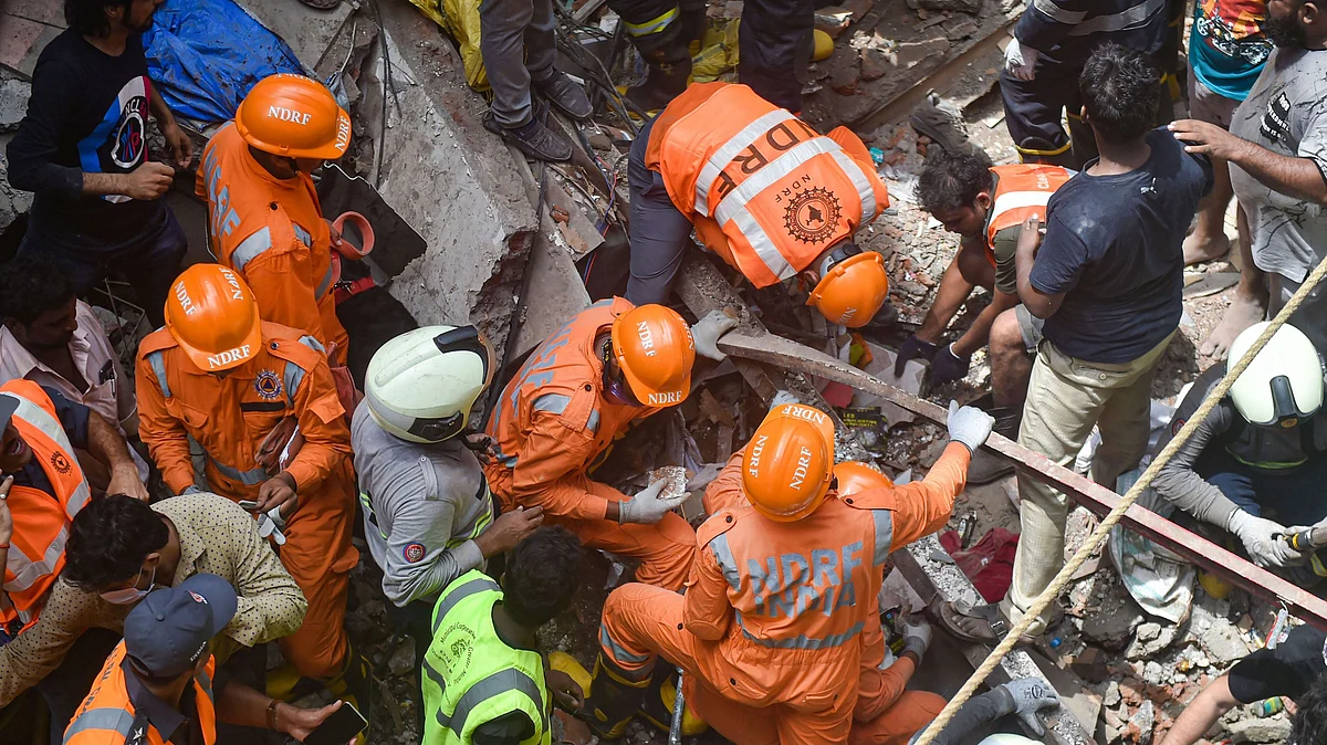Fire Brigade and NDRF personnel carry out rescue works after the collapse of the four-storey Kesarbai building at Dongri in Mumbai on 16 July 2019. 