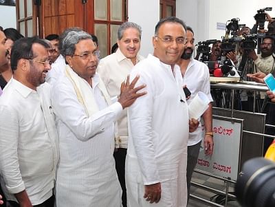 Bengaluru: Congress leaders Siddaramaiah and Dinesh Gundu Rao leave after the Congress Legislature Party (CLP) meeting at Vidhana Soudha in Bengaluru, on July 9, 2019. (Photo: IANS)