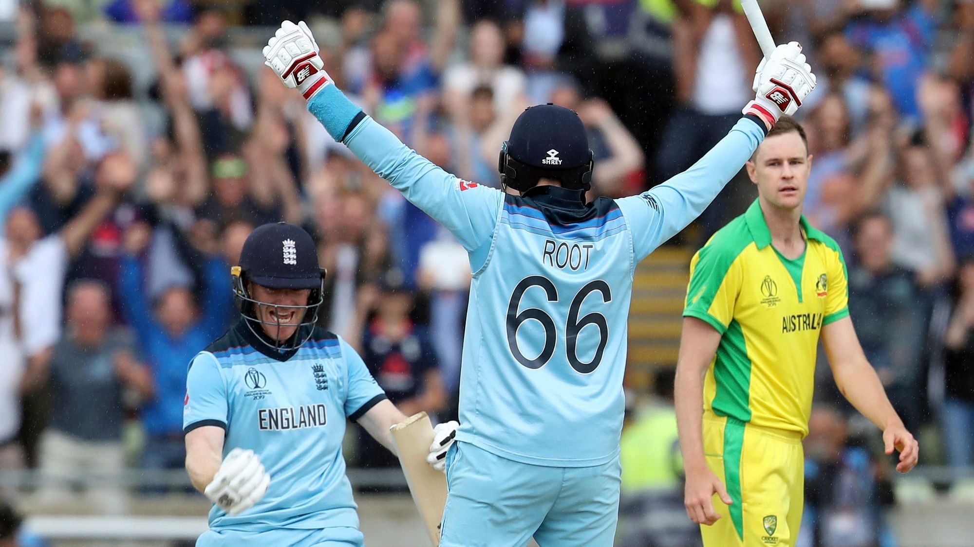 England’s captain Eoin Morgan, left, celebrates with teammate Joe Root after winning the Cricket World Cup semi-final match between Australia and England at Edgbaston in Birmingham.