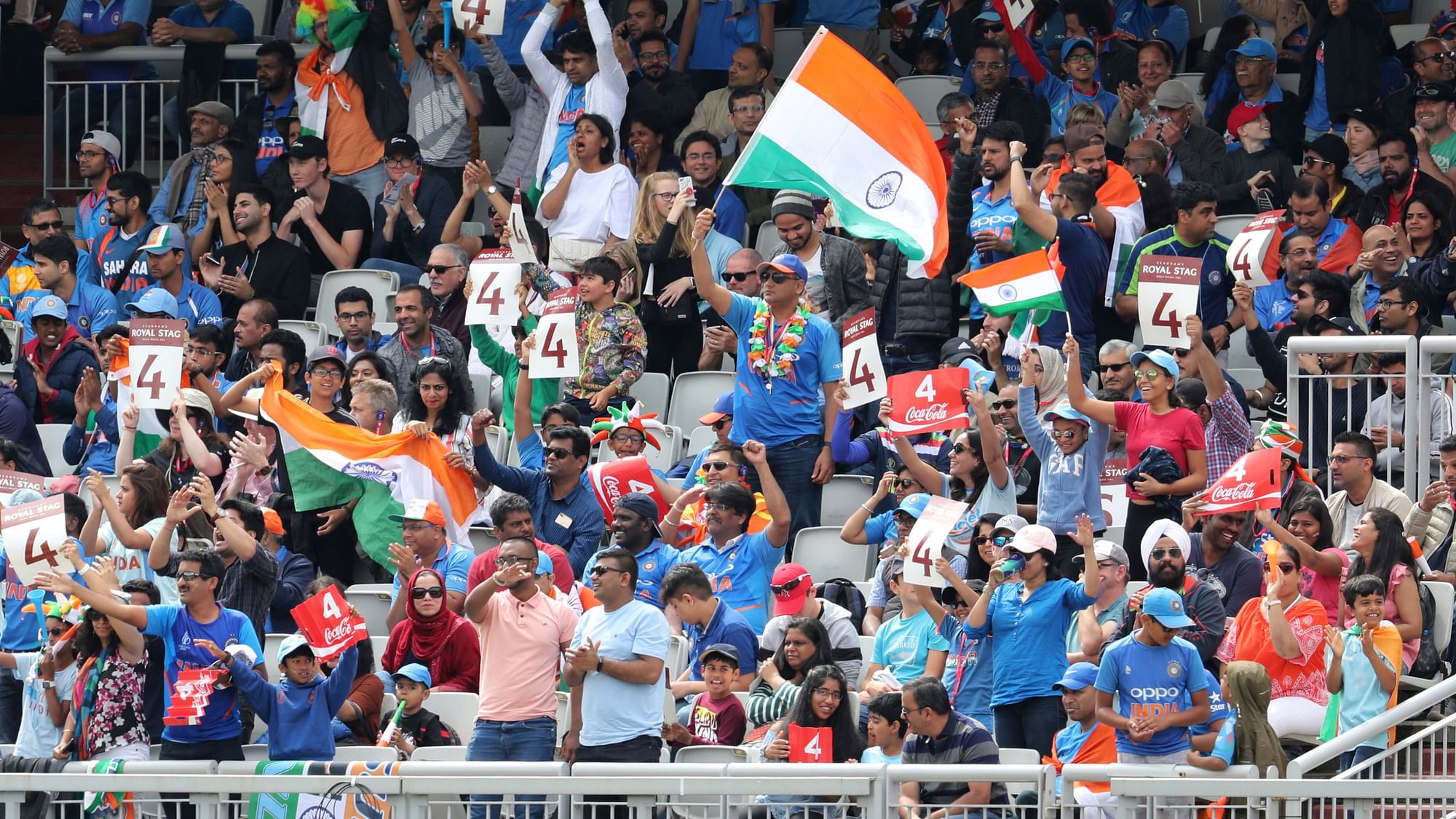 Indian cricket fans cheer for their team during the Cricket World Cup semifinal match between India and New Zealand at Old Trafford in Manchester, Wednesday, 10 July.