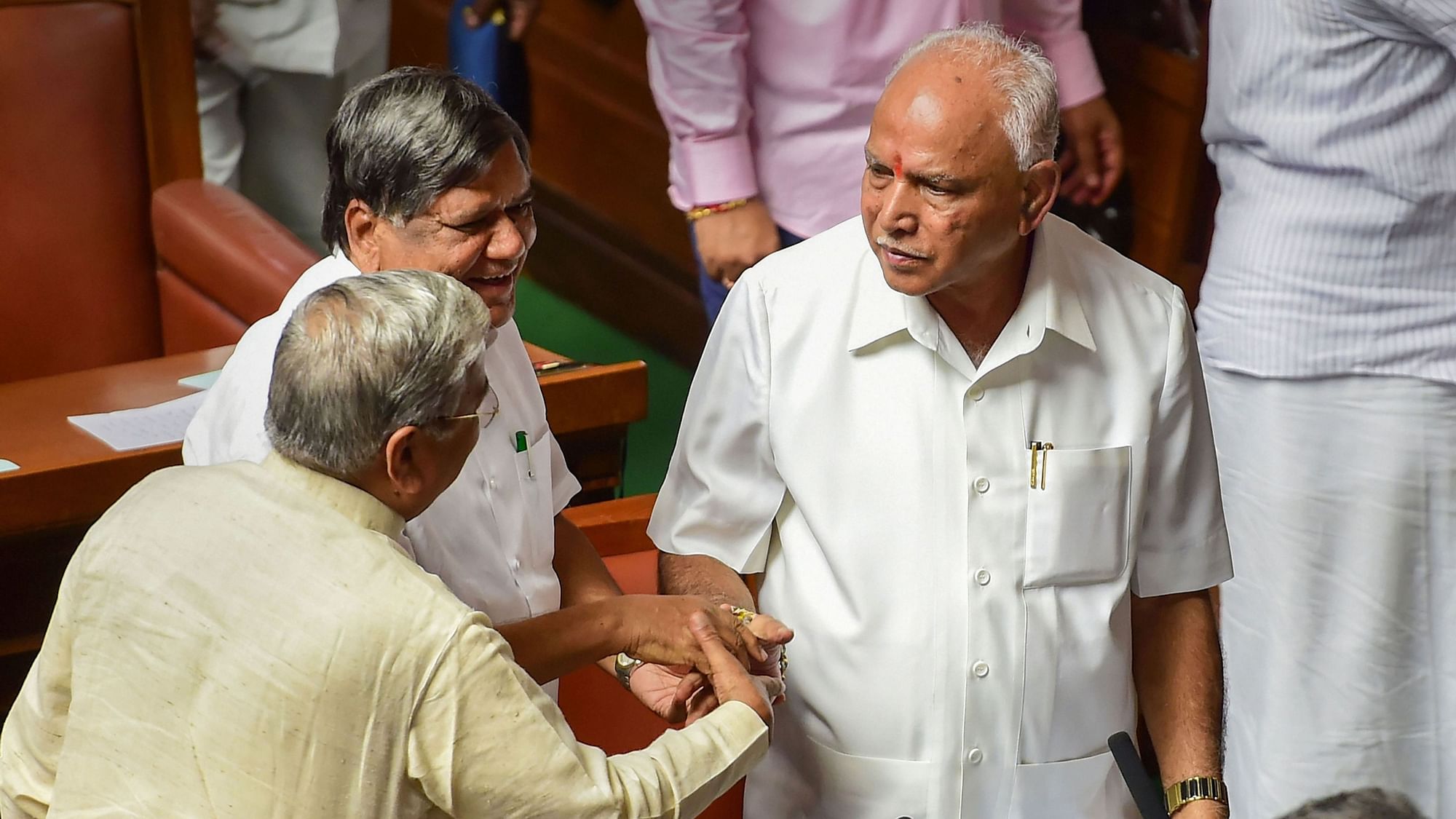 Karnataka CM BS Yediyurappa shakes hands with his party leaders and MLAs after proving majority in the Assembly on 29 July.